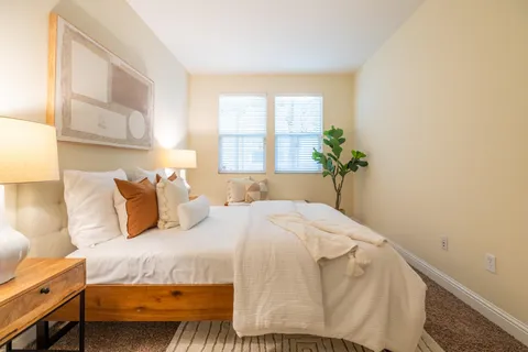 a bedroom with a bed and window