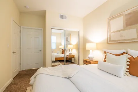 a bedroom with a bed and a large window