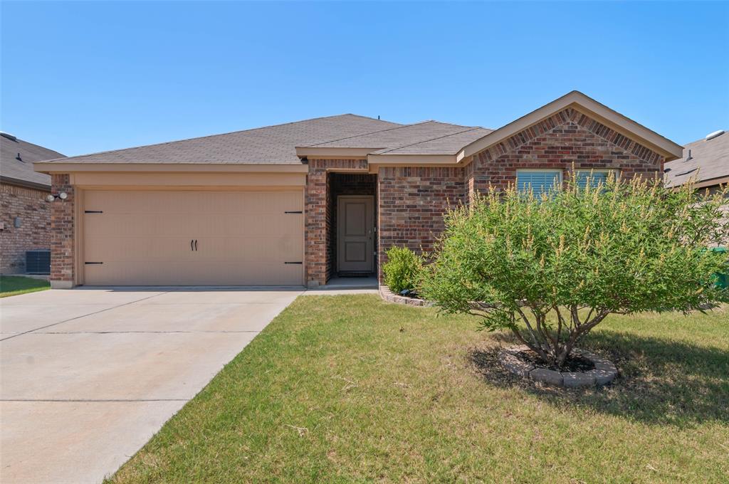 409 Wilson Way Denton, TX 76207 - Photo 29 of 33 Brick exterior featuring a two-car garage and a concrete driveway