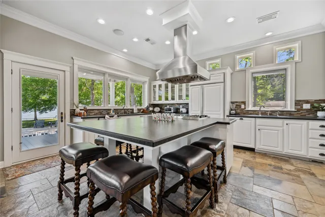 a kitchen with granite countertop a sink cabinets and window