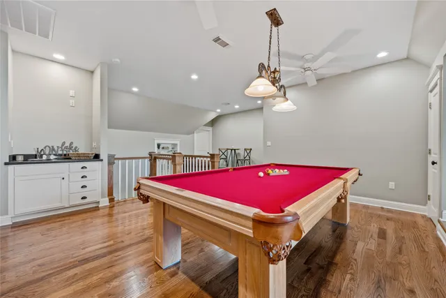 a dining room with furniture a rug and wooden floor