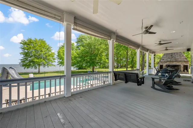 a living room with patio furniture and a floor to ceiling window