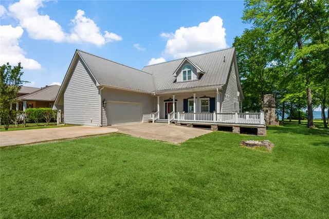 a view of a house with a backyard porch and sitting area