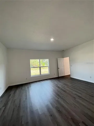 a view of room and wooden floor and window in a room