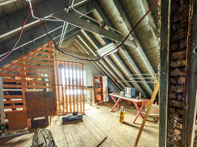 a view of a room with wooden floor
