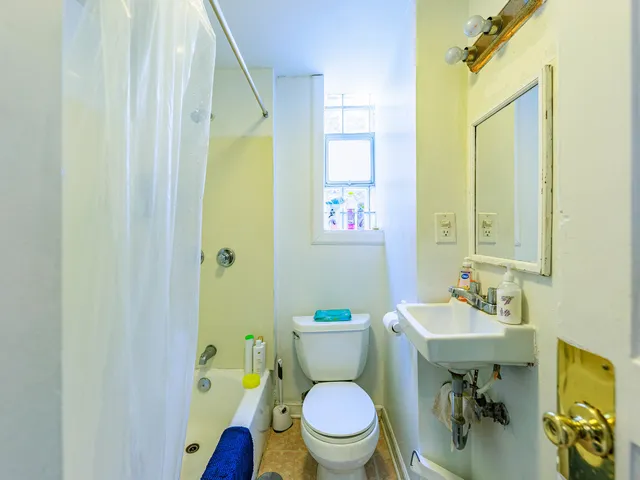 a bathroom with a sink a toilet and a mirror