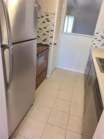 a kitchen with granite countertop a refrigerator and a stove