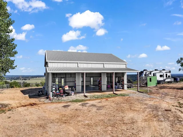 a view of a house with a yard and sitting area