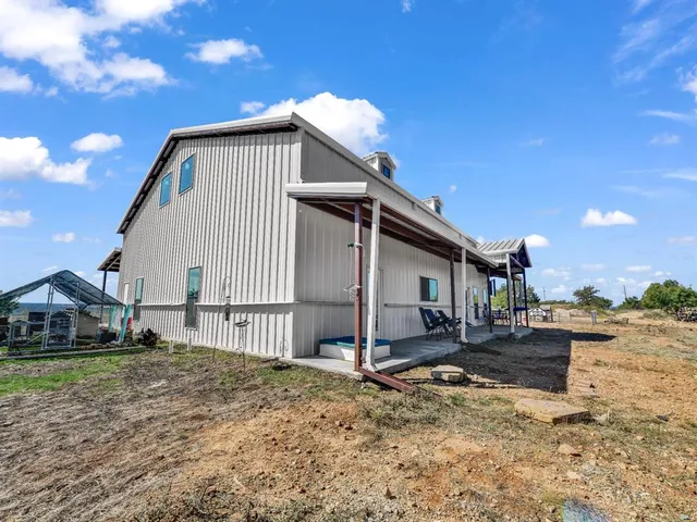 a view of a house with a yard and porch