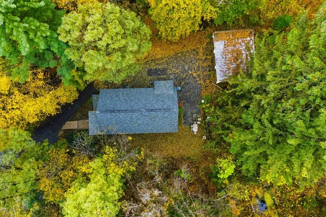 an aerial view of a house with a yard