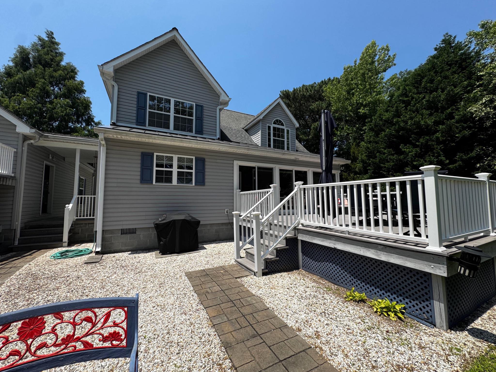 521 Painter Point Road Kilmarnock, VA 22482 - Photo 45 of 52 a view of a house with wooden deck and furniture