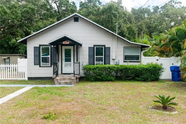 a view of a house with porch and garden