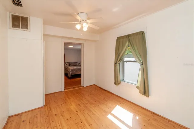 an empty room with windows and closet