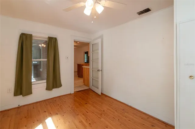 a view of a room with wooden floor and closet