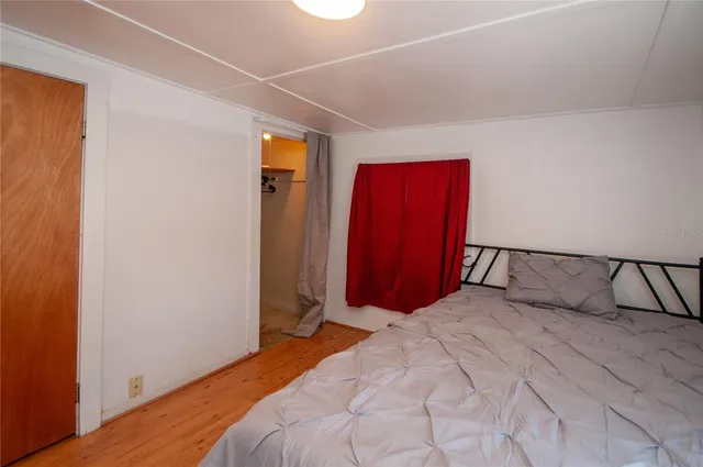 a bedroom with a large bed and a closet