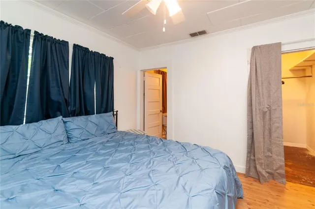 a bedroom with a bed and a window