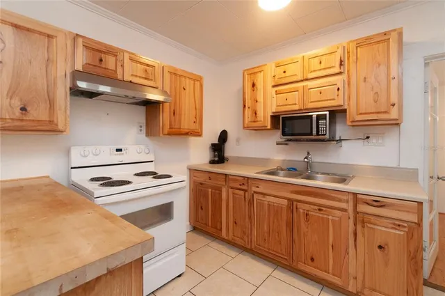 a kitchen with stainless steel appliances granite countertop a sink stove and microwave