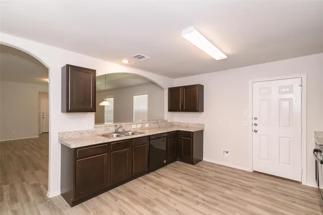 a spacious bathroom with a granite countertop double vanity sink and mirror