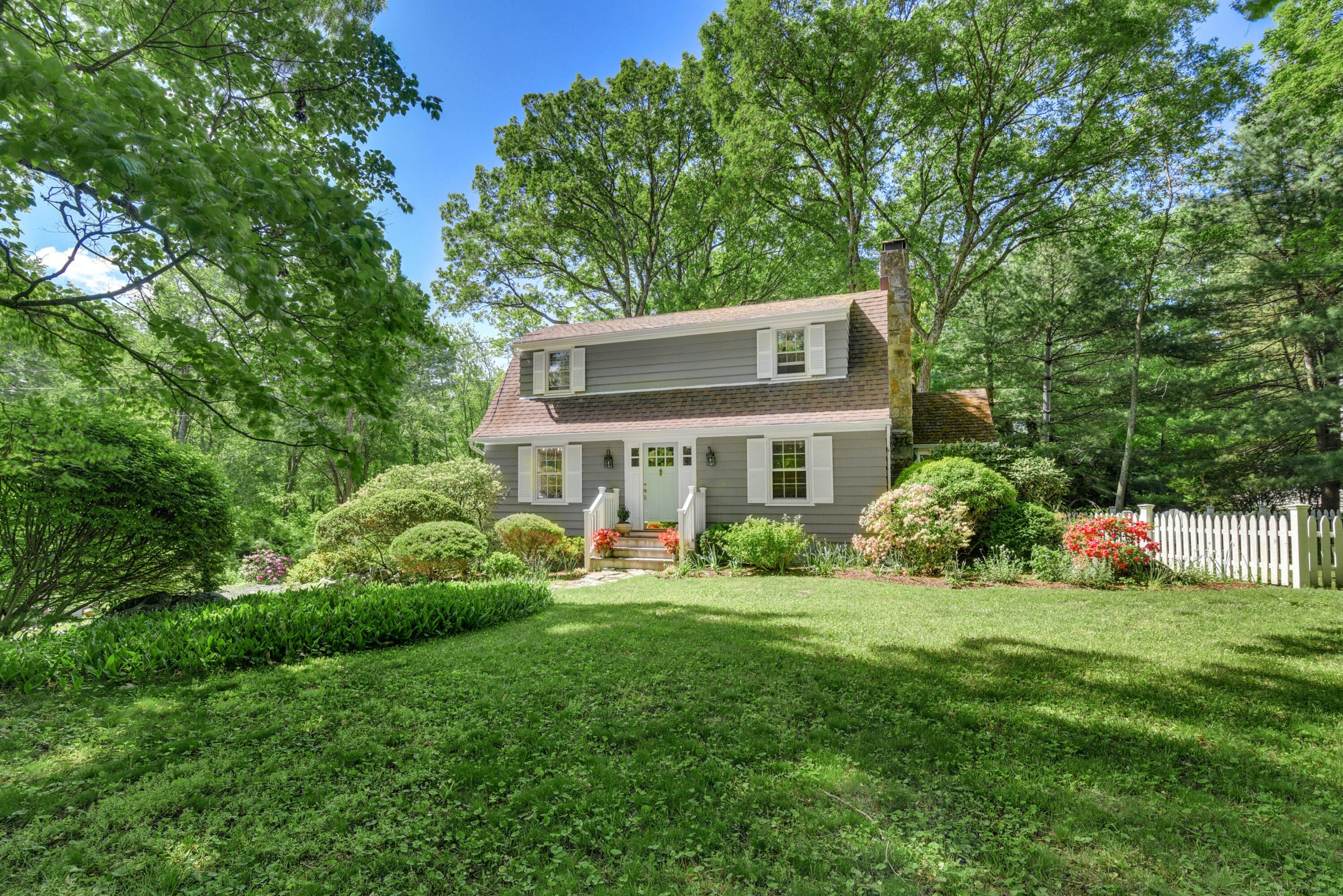 93 Westport Road Wilton, CT 06897 - Photo 2 of 31 a front view of a house with a yard table and chairs