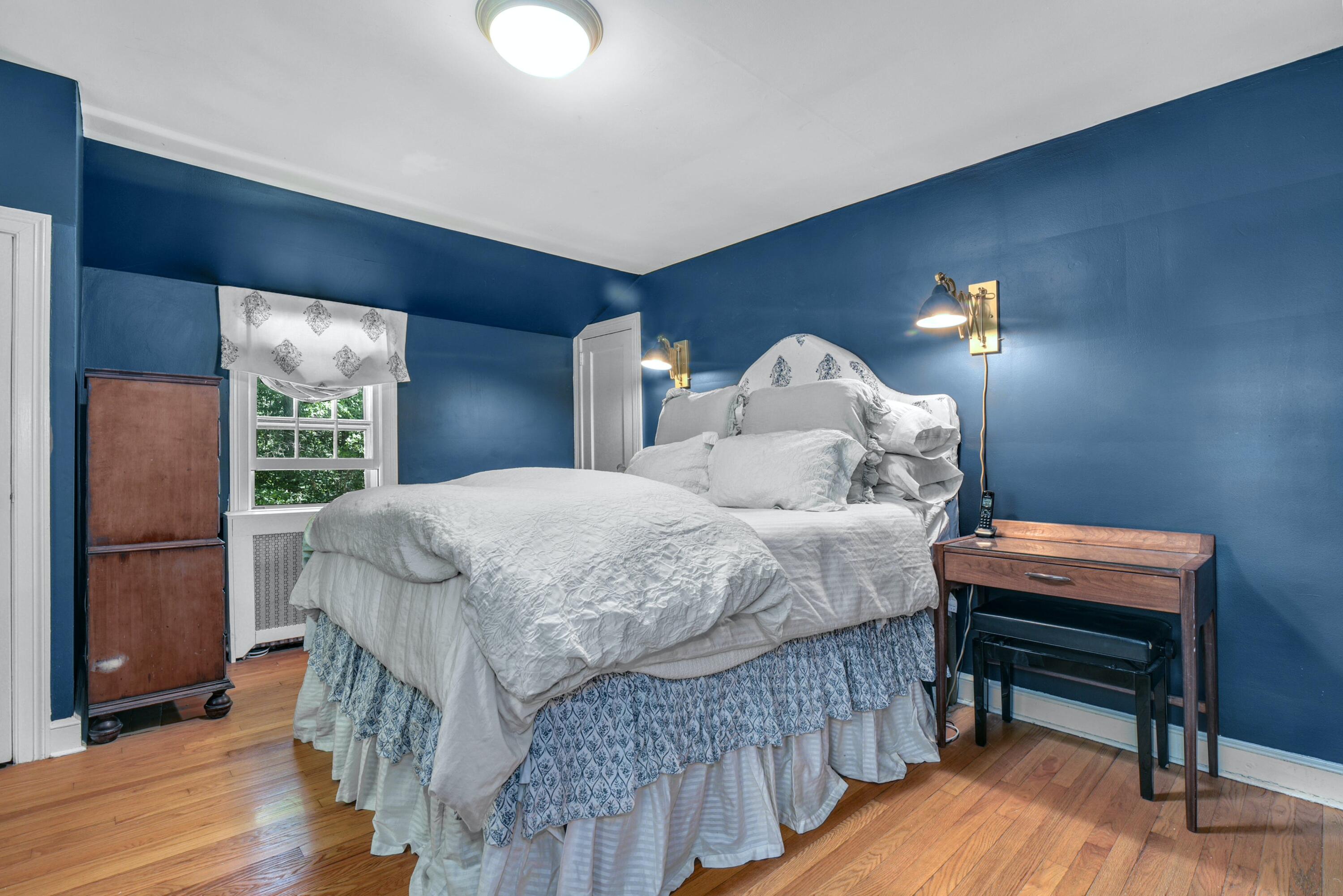 93 Westport Road Wilton, CT 06897 - Photo 15 of 31 a bedroom with a bed table and window
