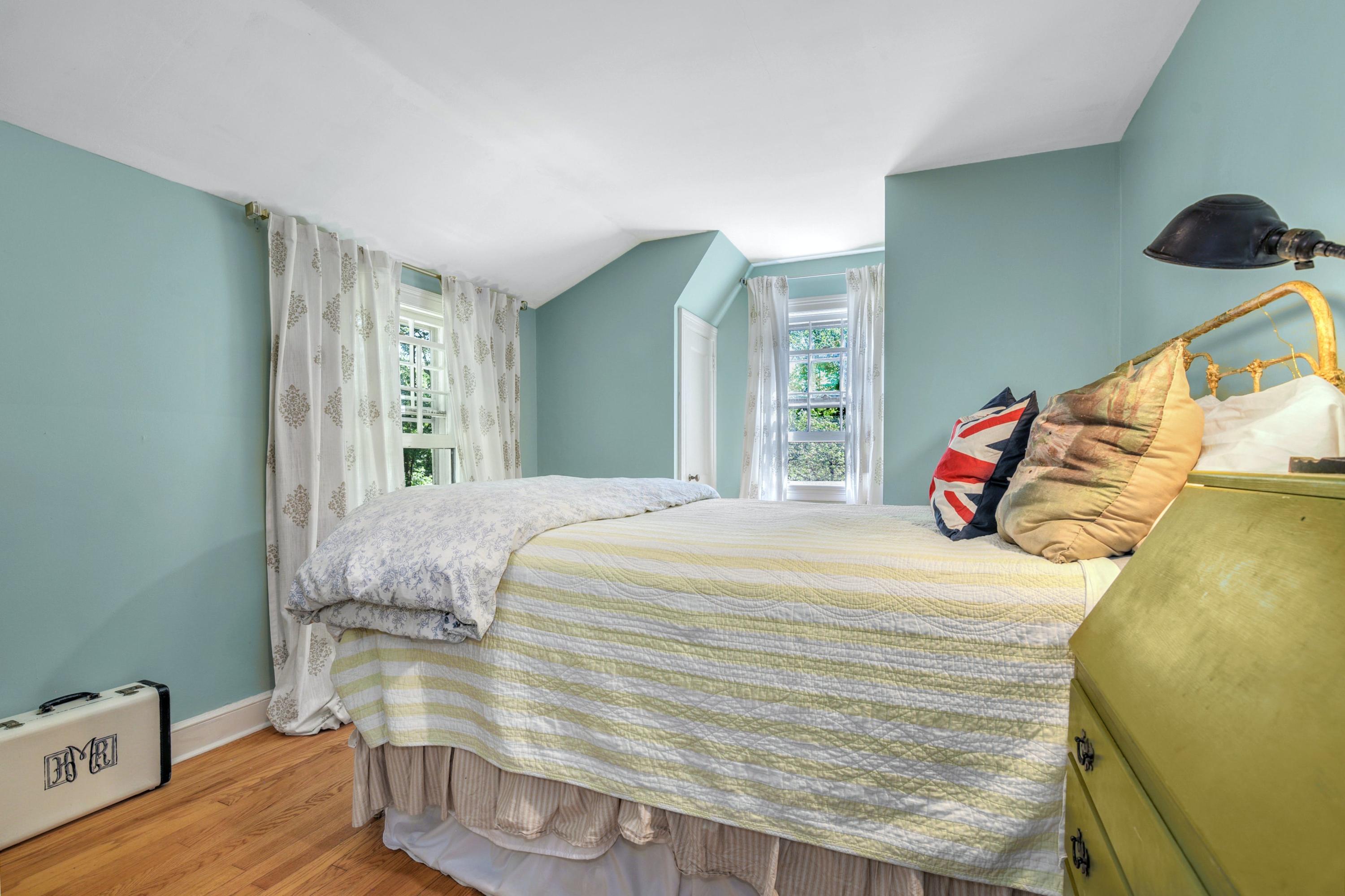 93 Westport Road Wilton, CT 06897 - Photo 16 of 31 a bedroom with a bed and wooden floor
