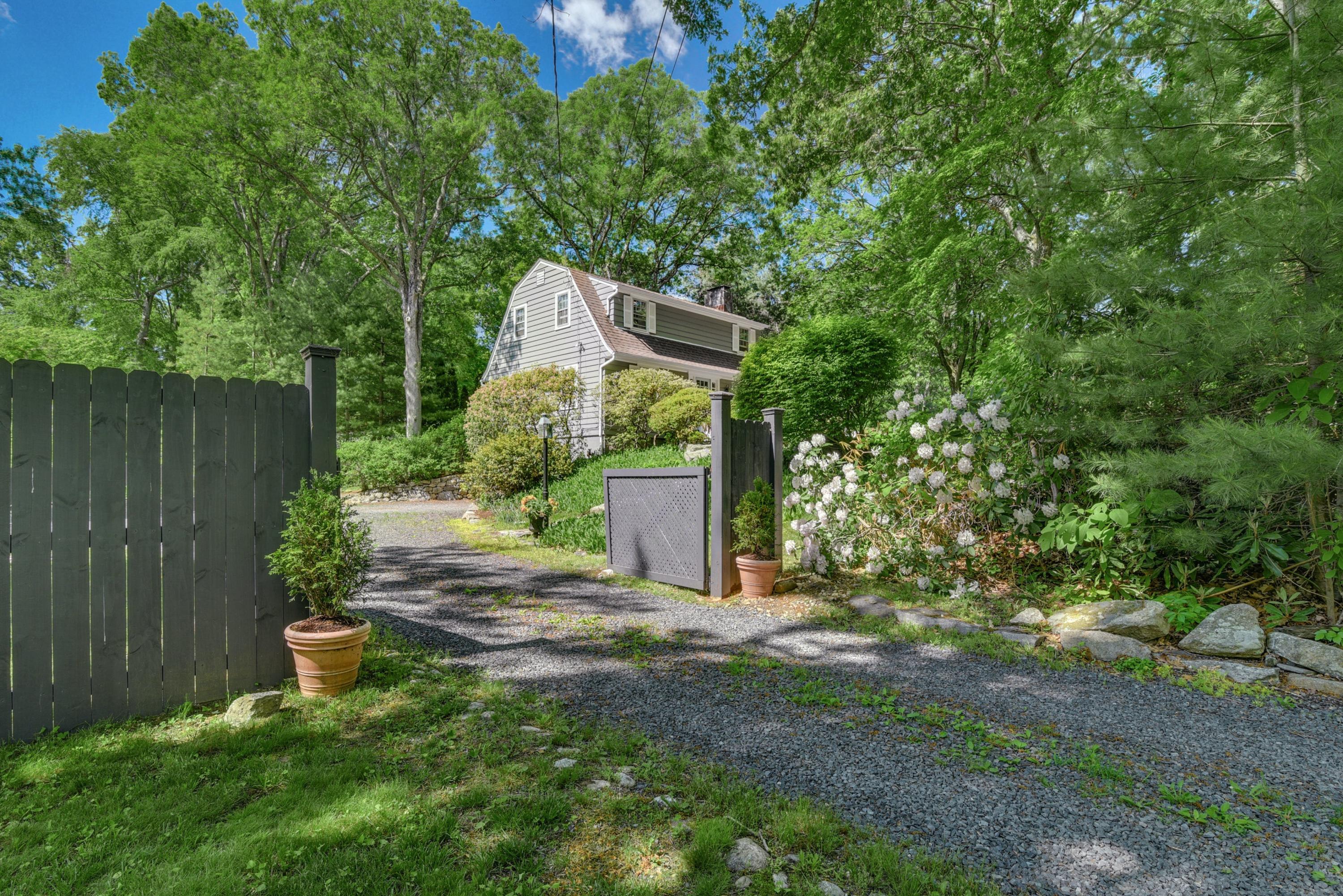 93 Westport Road Wilton, CT 06897 - Photo 28 of 31 a backyard of a house with lots of green space