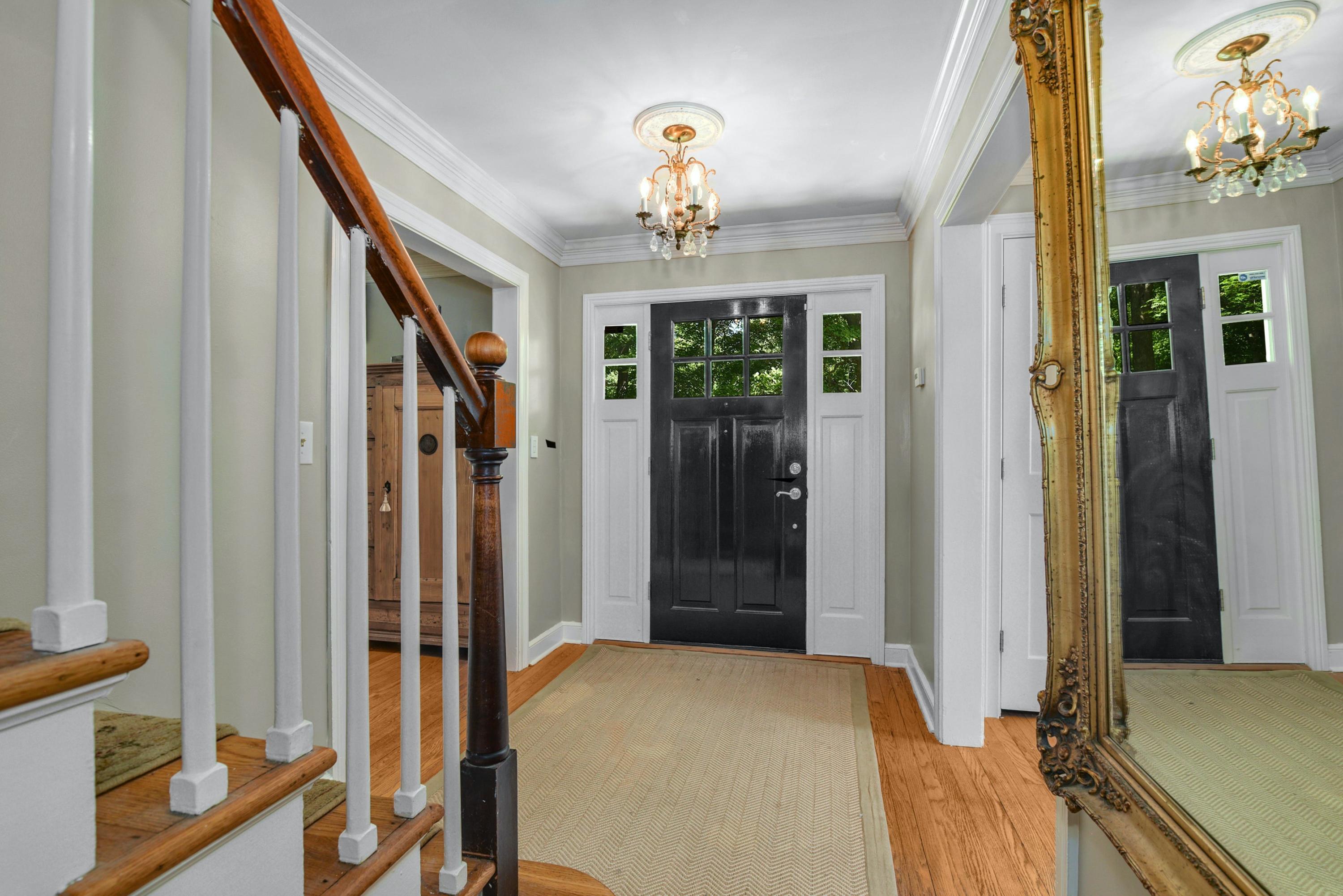 93 Westport Road Wilton, CT 06897 - Photo 4 of 31 a bedroom with a bed and a chandelier