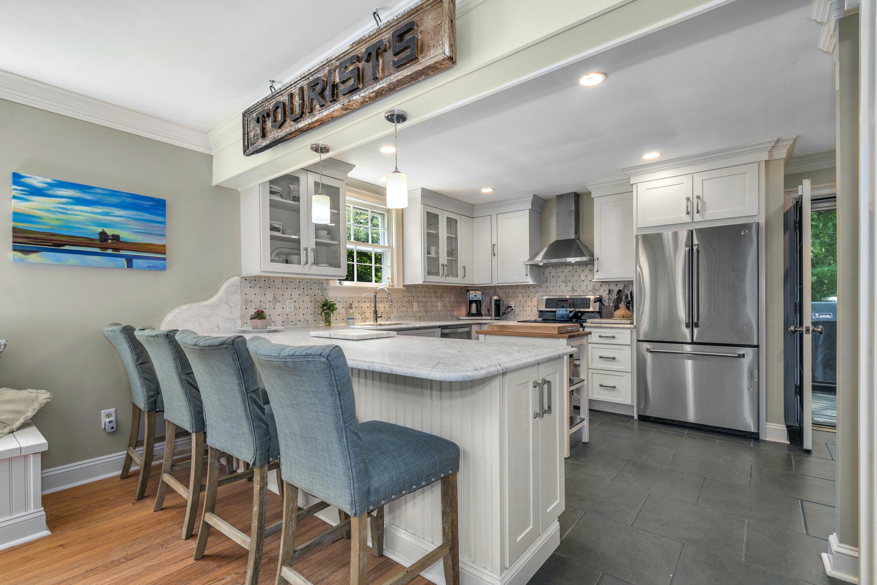 93 Westport Road Wilton, CT 06897 - Photo 9 of 31 a kitchen with stainless steel appliances granite countertop a white cabinets and a refrigerator