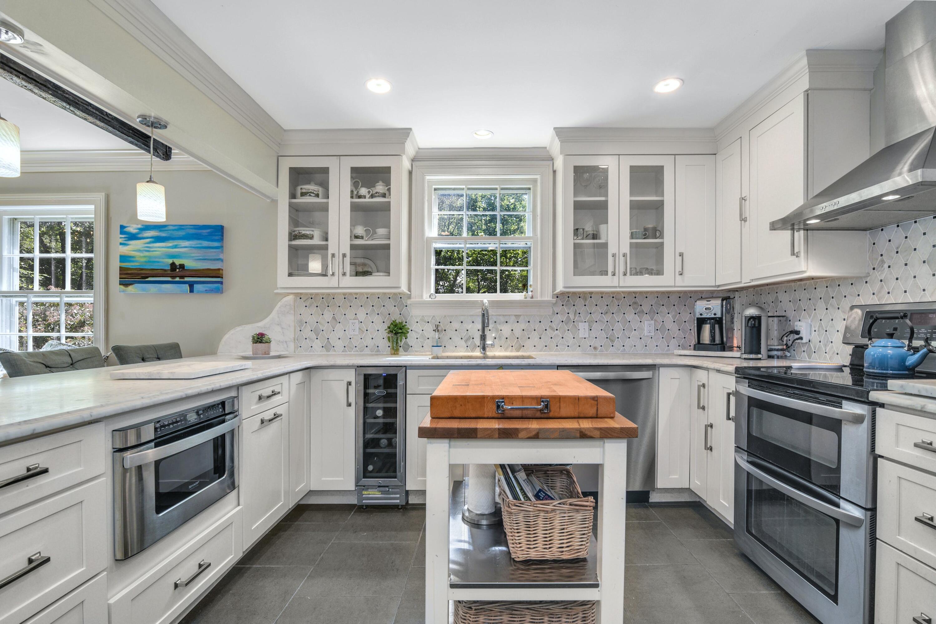 93 Westport Road Wilton, CT 06897 - Photo 10 of 31 a kitchen with stainless steel appliances granite countertop a stove sink and cabinets