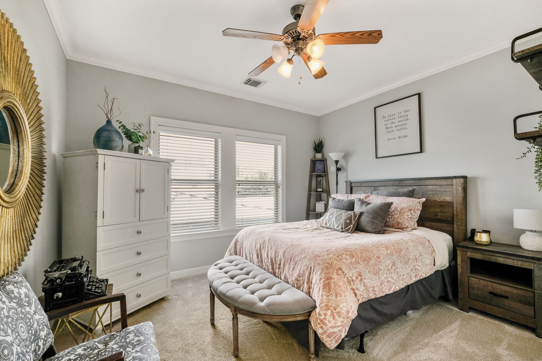933 West 17th Street Houston, TX 77008 - Photo 12 of 19 Large secondary bedroom featuring neutral paint, plush carpet, crown molding details, large window with privacy blinds, and a ceiling fan.