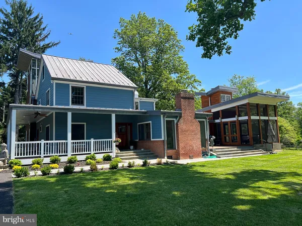 a view of house with yard and front view of a house
