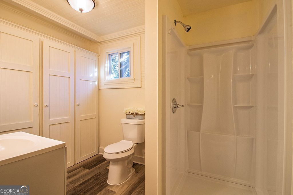 65 East Calhoun Street Wadley, GA 30477 - Photo 11 of 25 a bathroom with a toilet and a shower