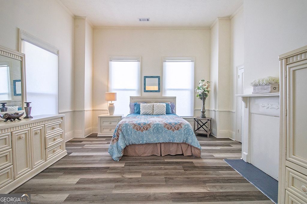 65 East Calhoun Street Wadley, GA 30477 - Photo 13 of 25 a spacious bedroom with a bed and a large window