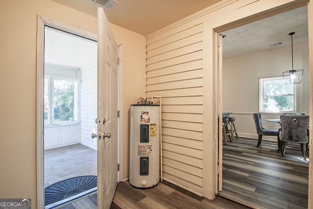 65 East Calhoun Street Wadley, GA 30477 - Photo 16 of 25 a view of a hallway with wooden floor and staircase