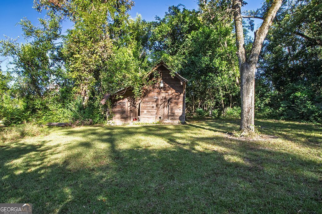65 East Calhoun Street Wadley, GA 30477 - Photo 21 of 25 a backyard of a house with a yard and outdoor seating