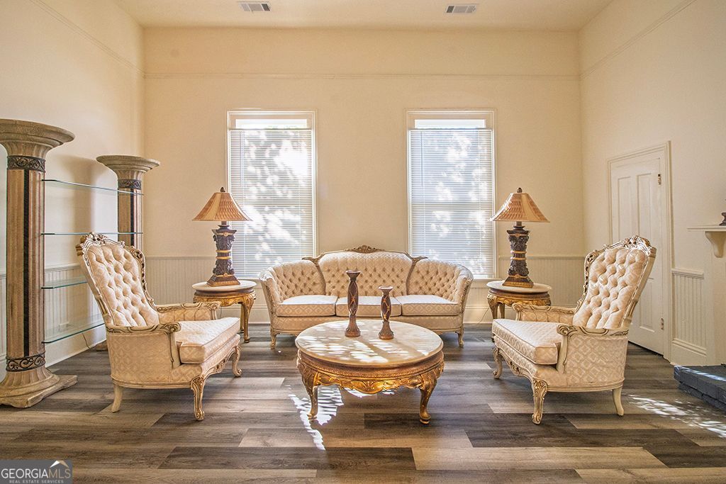 65 East Calhoun Street Wadley, GA 30477 - Photo 4 of 25 a living room with fireplace a table and chairs