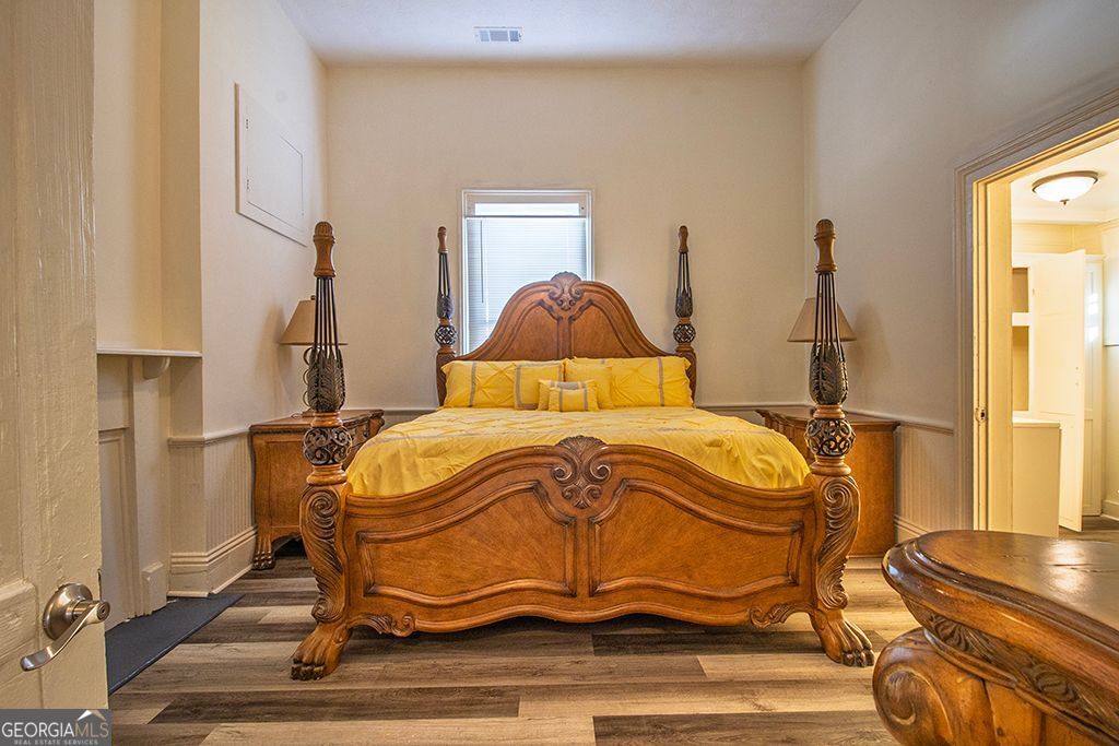 65 East Calhoun Street Wadley, GA 30477 - Photo 10 of 25 a bedroom with a bed and wooden floor
