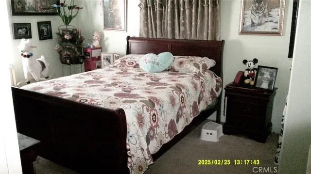 a bedroom with a bed and a mirror on dresser