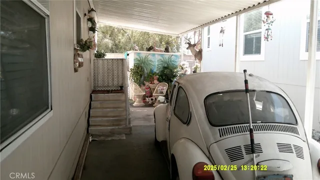 a view of a porch with furniture and garden