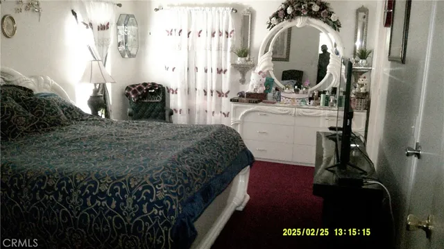 a bedroom with a bed and a mirror