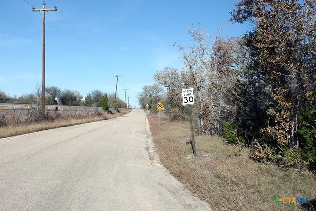 a view of a road with a building in the background