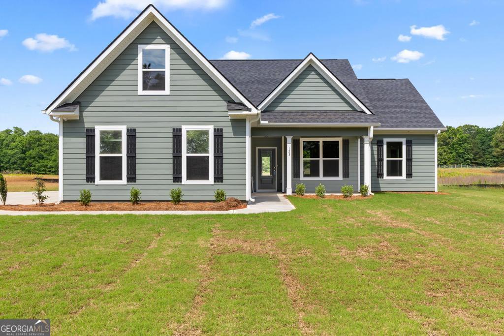 123 Oak Road Locust Grove, GA 30248 - Photo 1 of 1 a front view of a house with a garden and porch
