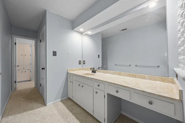 a white toilet sitting next to a bathroom sink