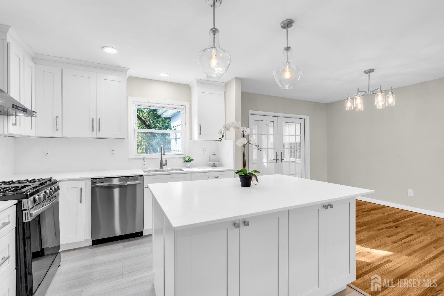 1322 Marcella Drive Union, NJ 07083 - Photo 21 of 48 a kitchen with a sink a stove a refrigerator and white cabinets