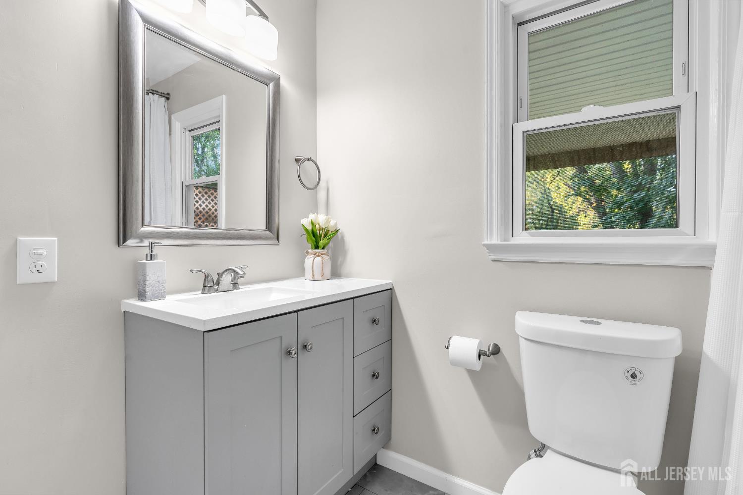 1322 Marcella Drive Union, NJ 07083 - Photo 27 of 48 a bathroom with a toilet sink and mirror