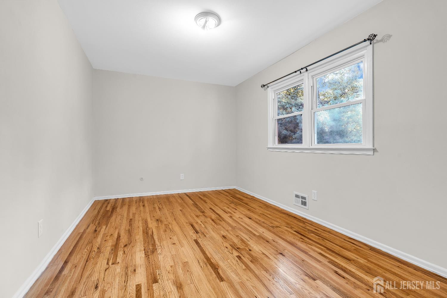 1322 Marcella Drive Union, NJ 07083 - Photo 34 of 48 a view of empty room with wooden floor and fan