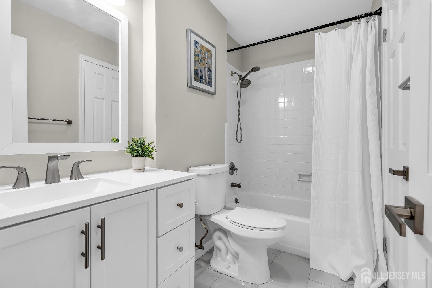 1322 Marcella Drive Union, NJ 07083 - Photo 38 of 48 a bathroom with a toilet a sink and a mirror