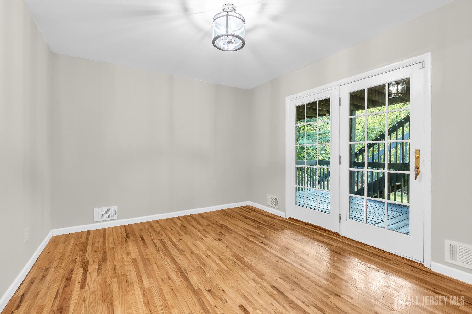 1322 Marcella Drive Union, NJ 07083 - Photo 6 of 48 a view of empty room with wooden floor and fan