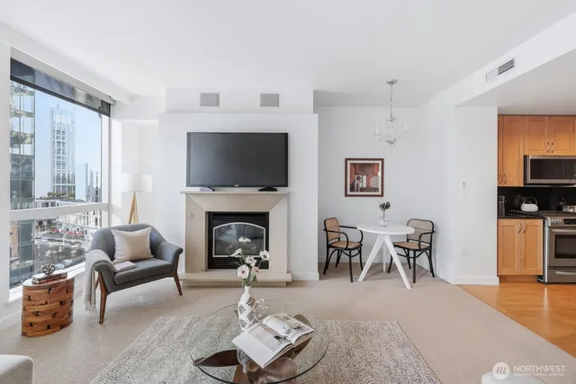 a living room with furniture a flat screen tv and a fireplace