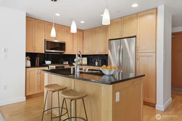 a kitchen with stainless steel appliances a refrigerator stove microwave and cabinets